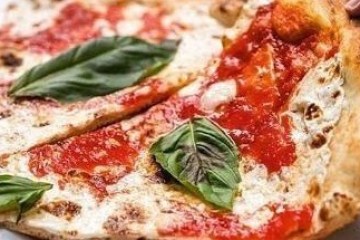 close up of cheese pizza with basil